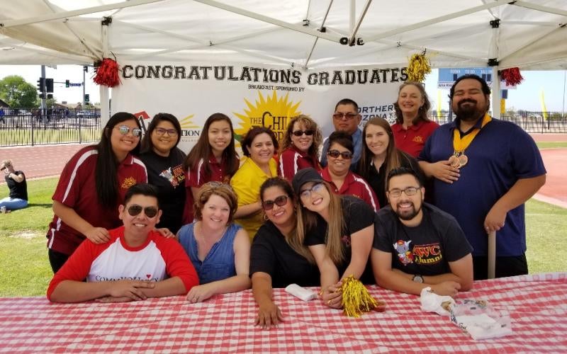 AWC Alumni volunteers serving Chili Pepper to graduates